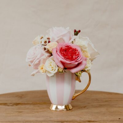 Christina Re teacup posy with fresh pink and white roses