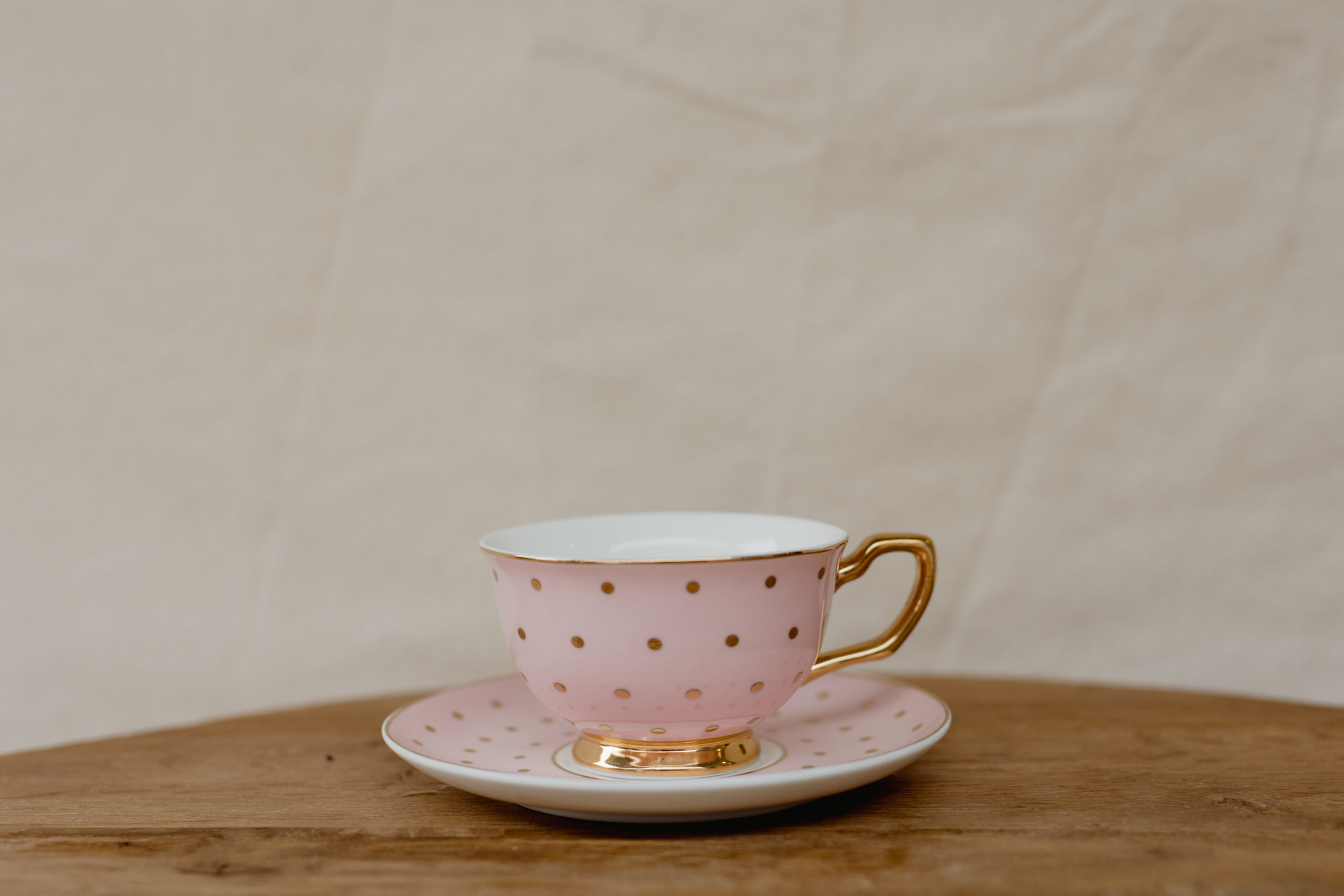 pink and gold spot teacup with fresh flowers