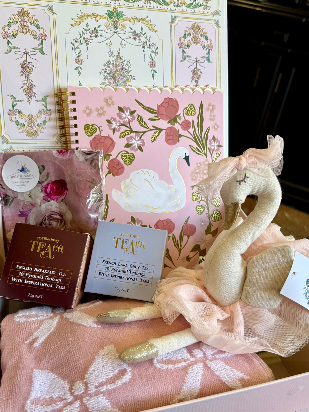 A heartfelt mother and baby hamper from Mayflowers Florist Newcastle. Includes a swan toy, bow towel, tea, silk handkerchief and more.