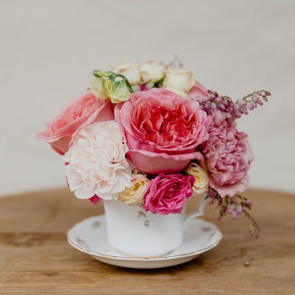 bright roses in white, pinks and purples inside beautiful antique teacup delivered in Newcastle