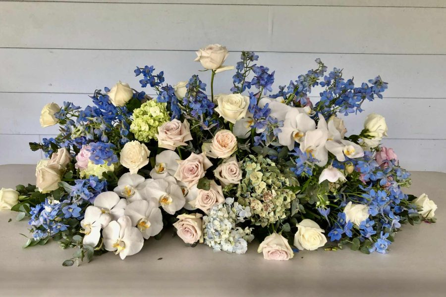 custom funeral flowers for coffin in blues and whites