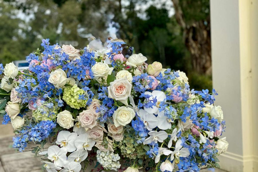 custom funeral flowers for coffin in blues and whites