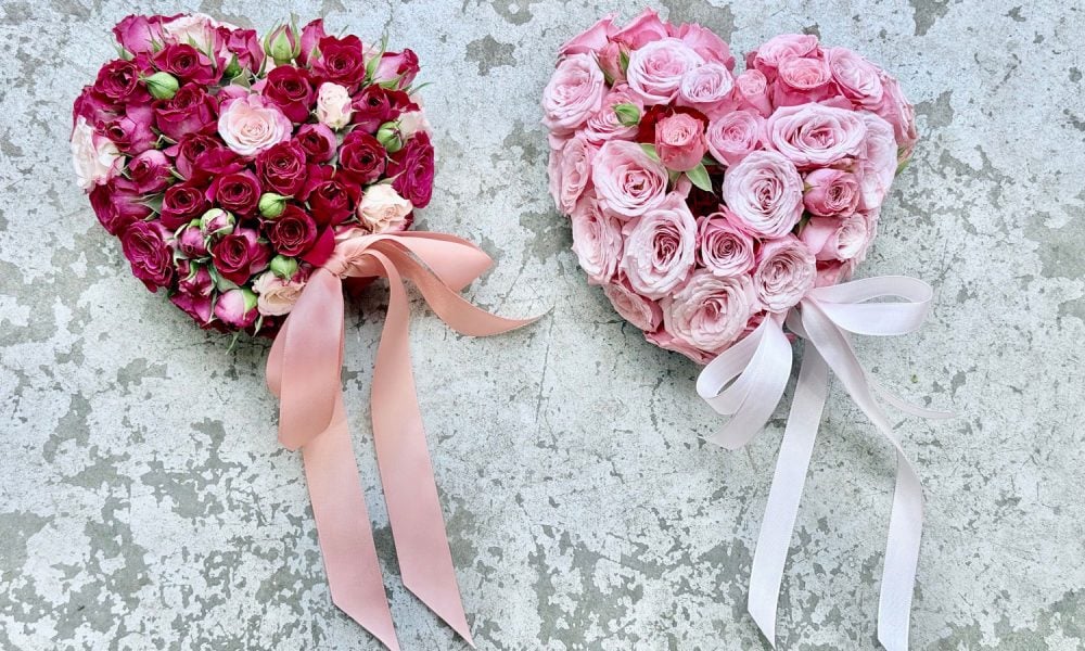 two rose floral arangements for valentines day. One has red roses and one has pink roses.